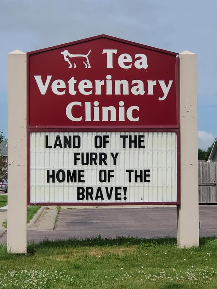 The real roadside board out on Figzel Court: LAND OF THE FURRY HOME OF THE BRAVE!